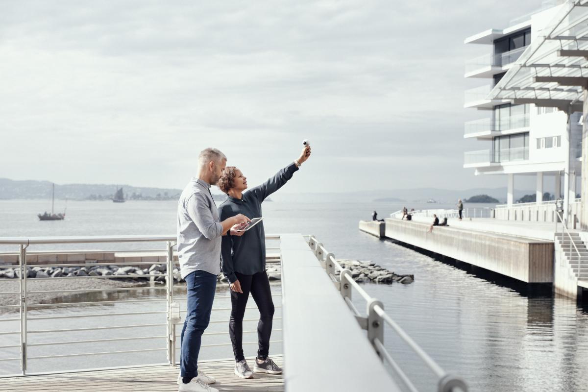 A woman and man standing on a pier 
